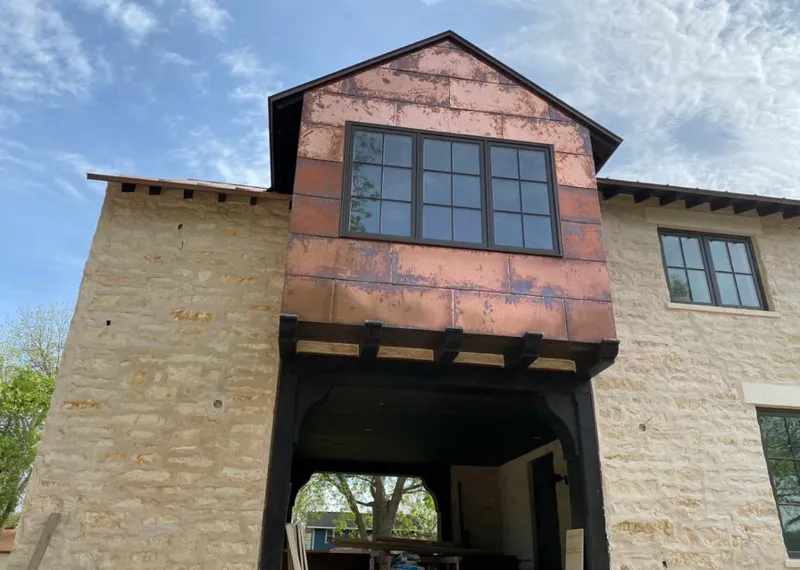 Copper metal panel facade on a stone building for Roof Repair in Lafayette