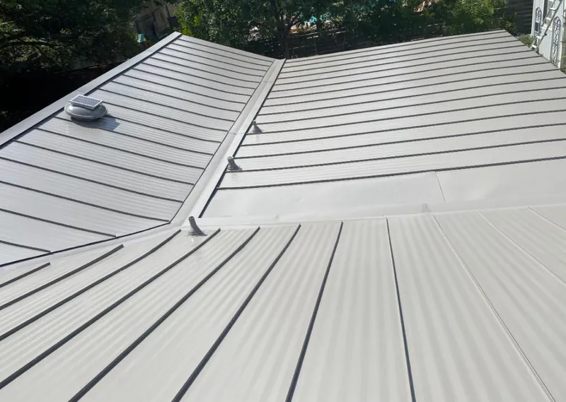 Solar attic fan installed on a metal roof for Roof Ventilation in Lafayette